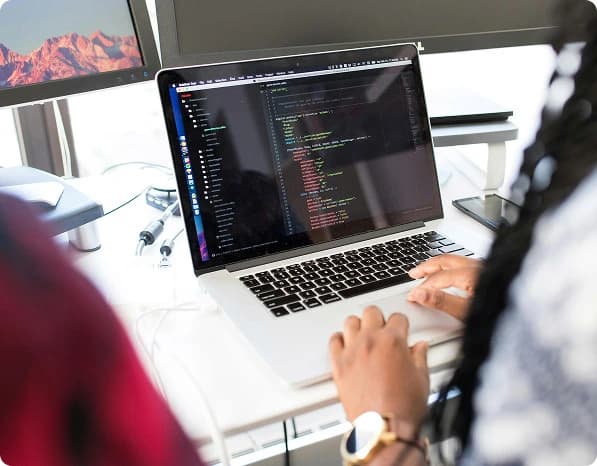 Developer working across multiple screens on a Shopify build